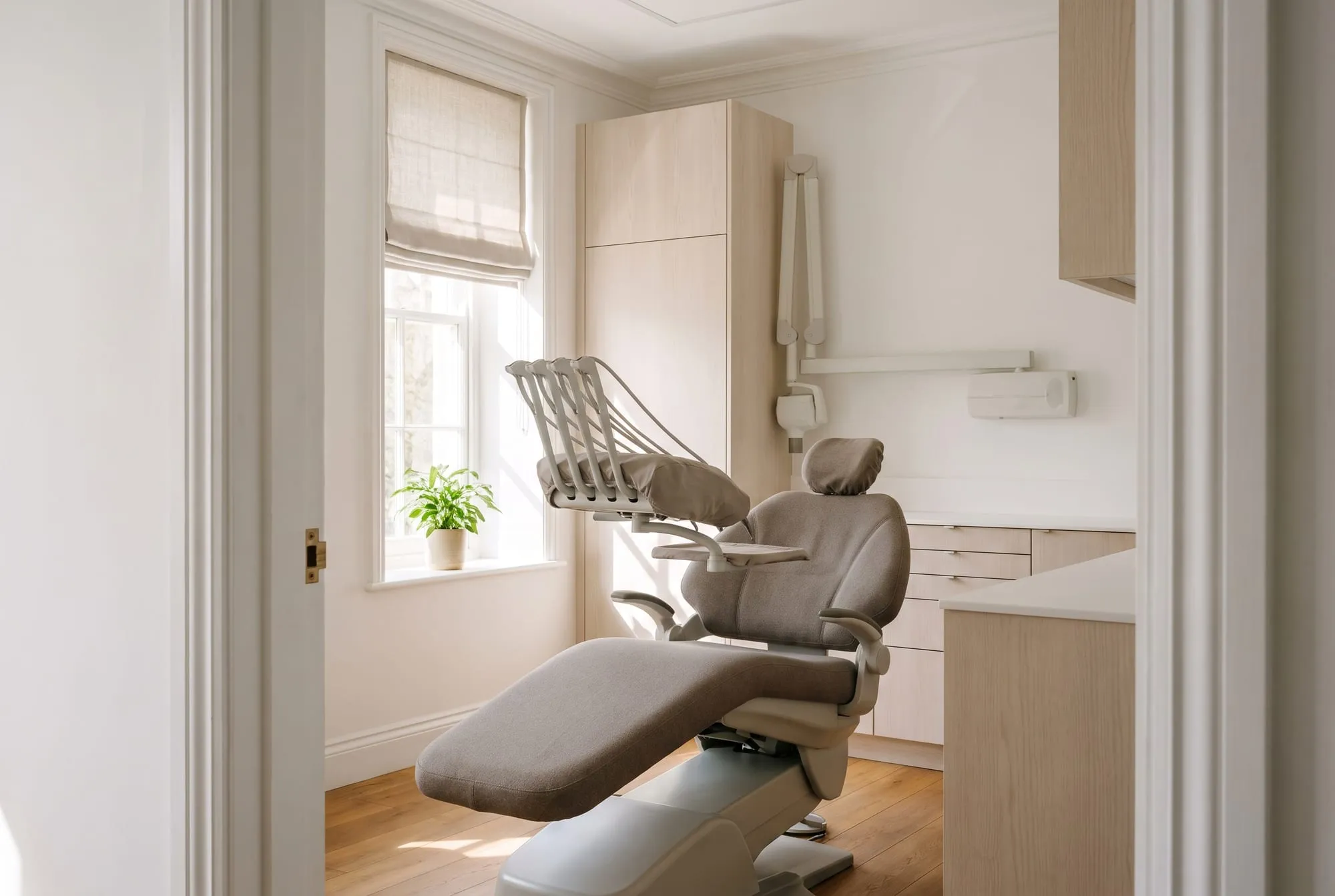 A surgery with the chair reclined and the window blind half open